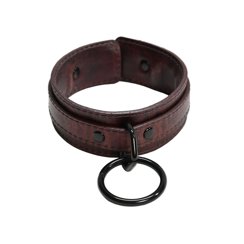A dark red leather collar with a black metal O-ring and black rivets, displayed on a white background.