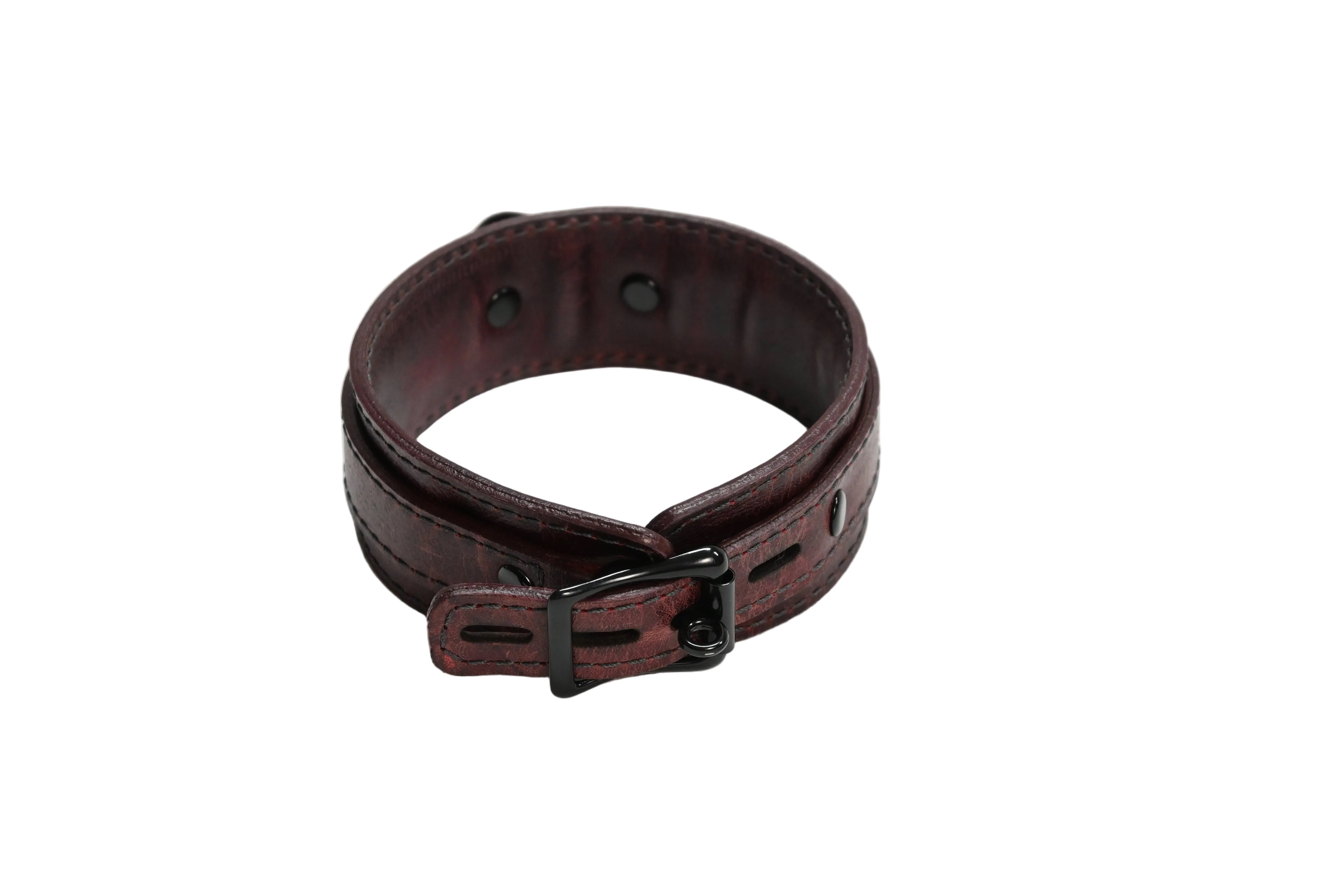 A dark red leather collar with a black metal buckle, photographed on a white background.