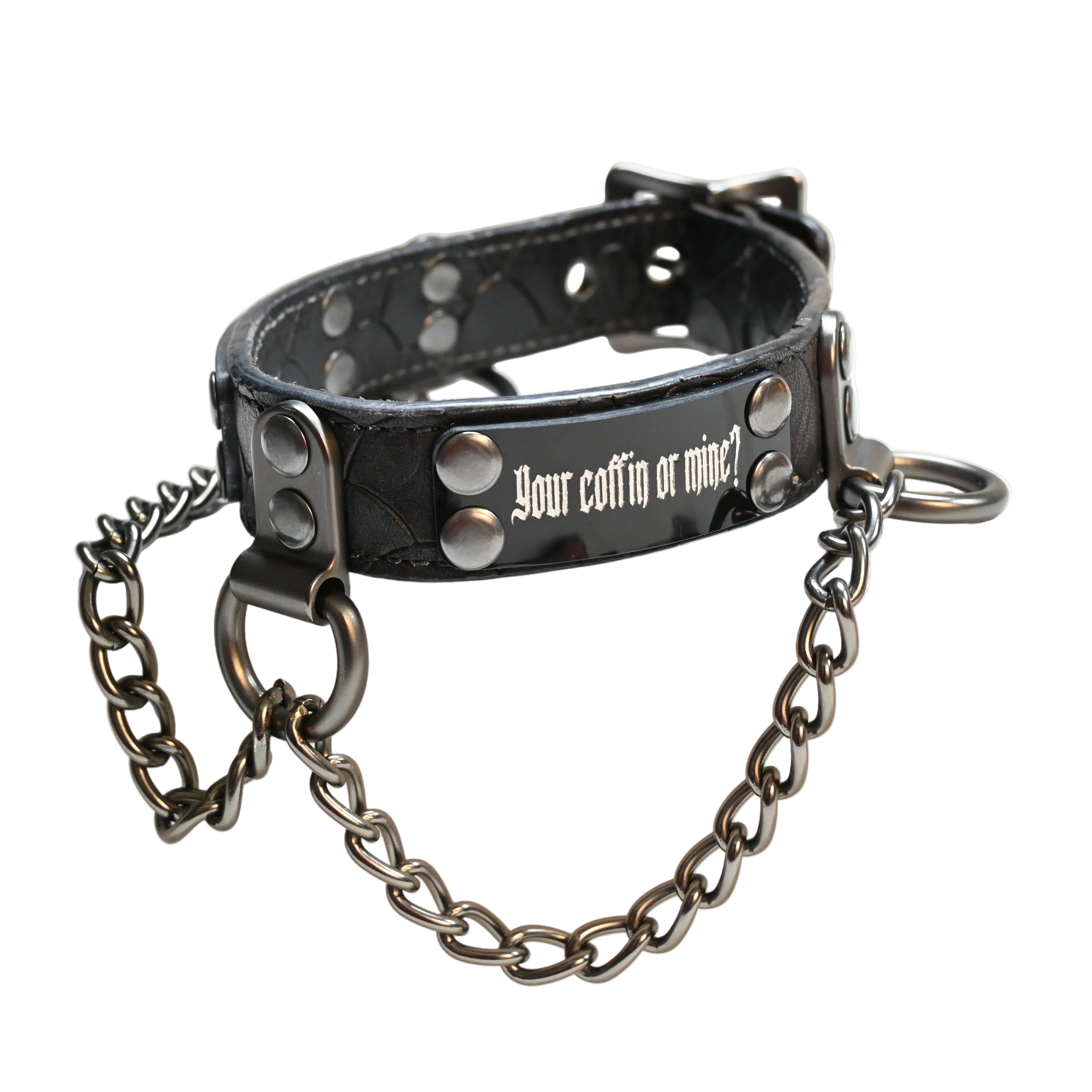 A black leather collar with silver studs, a black metal chain, and the text 'your coffin or mine?' printed in white on the front, resting on a white background.