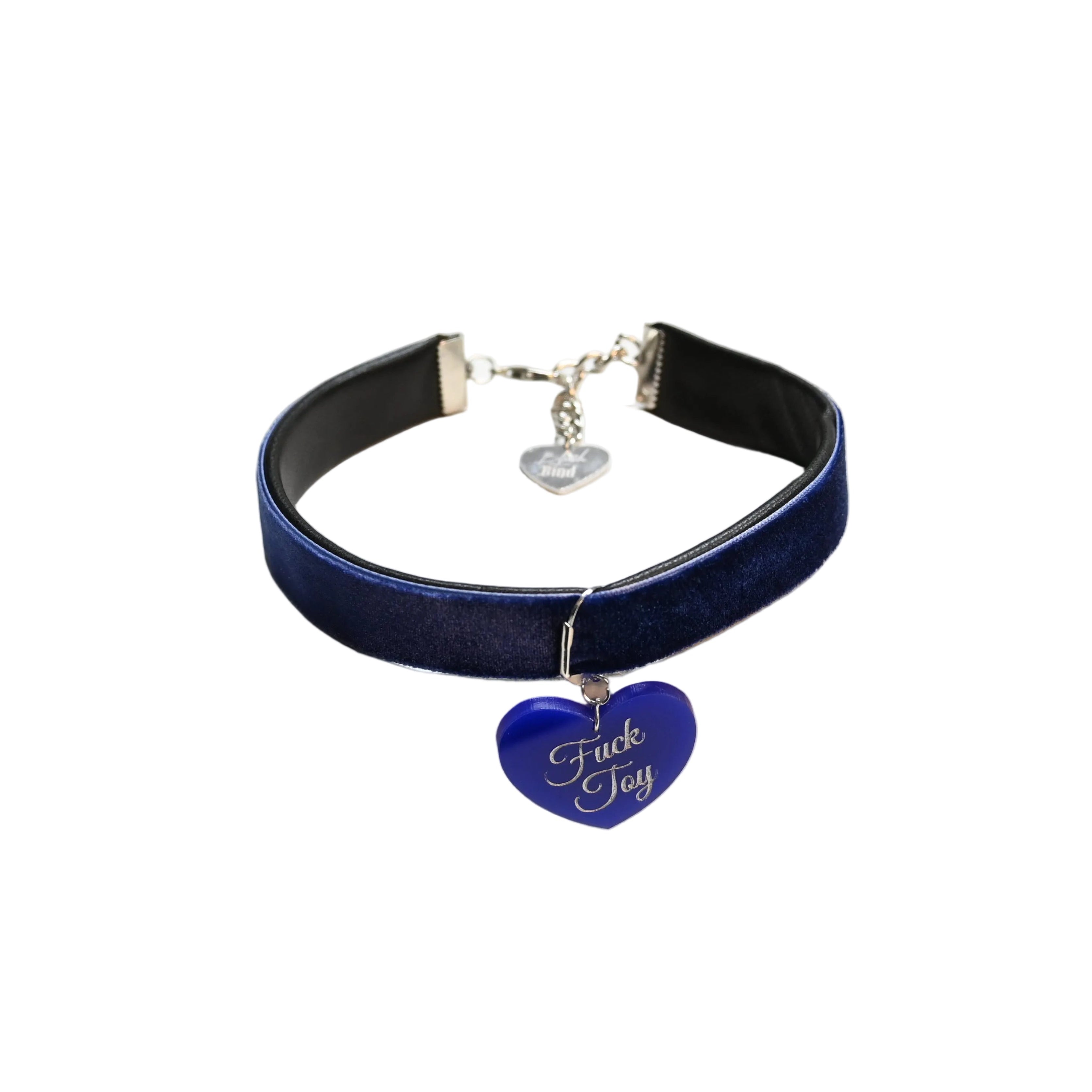 A dark blue velvet choker collar with a silver-tone metal clasp and a blue heart-shaped charm engraved with the words 'Fuck Toy' in white script, displayed on a white background.
